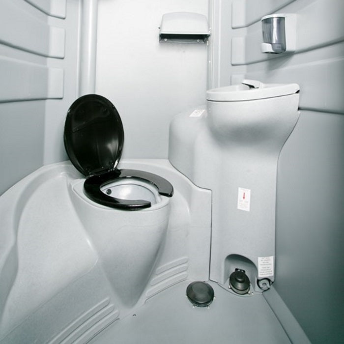The interior of a flushable porta potty rental showcasing its hygienic design and eco-friendly features for a comfortable and clean experience.